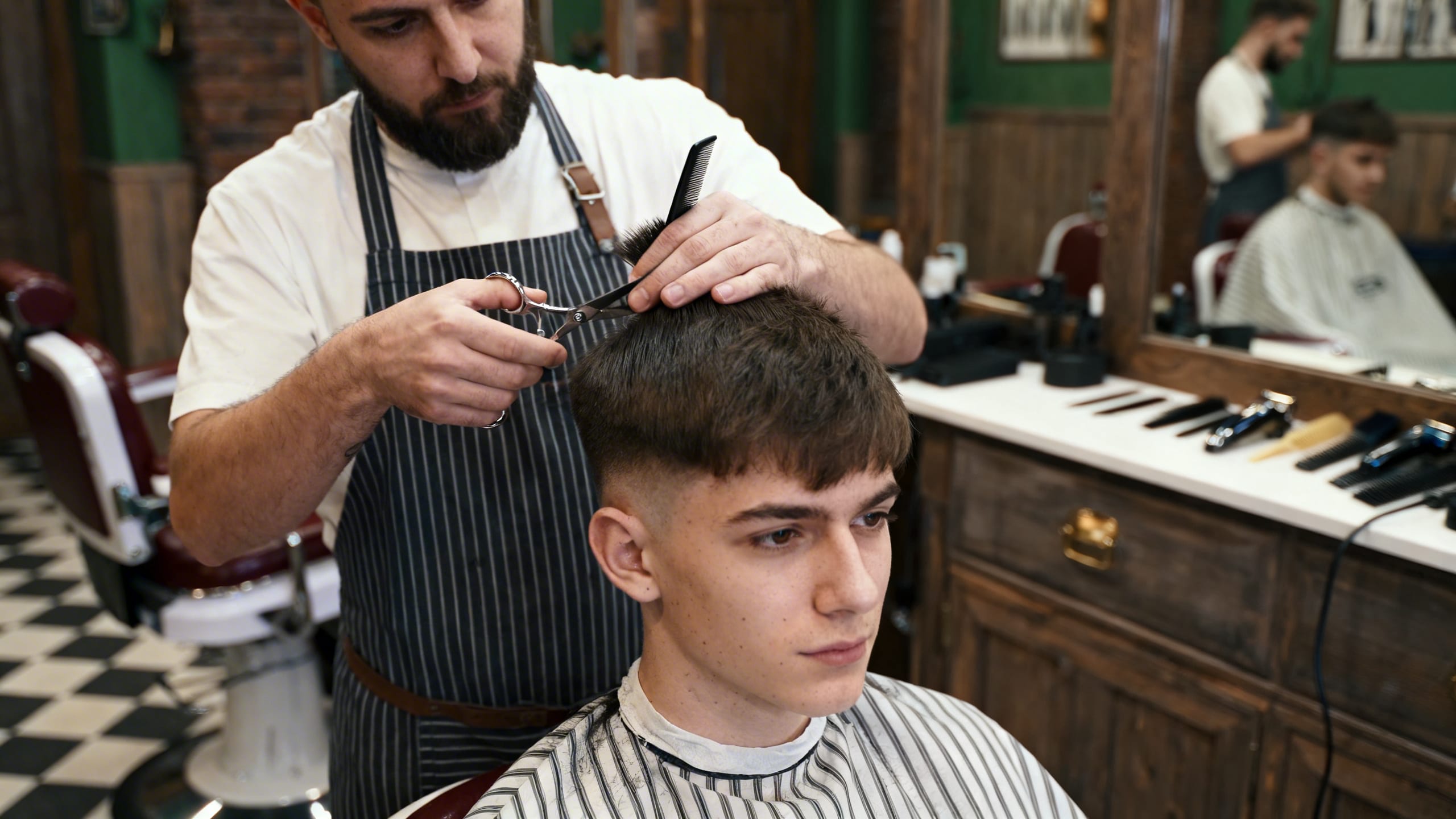 barber giving a young man a haircut